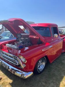 Beautiful red pick up truck with pristine engine on display 